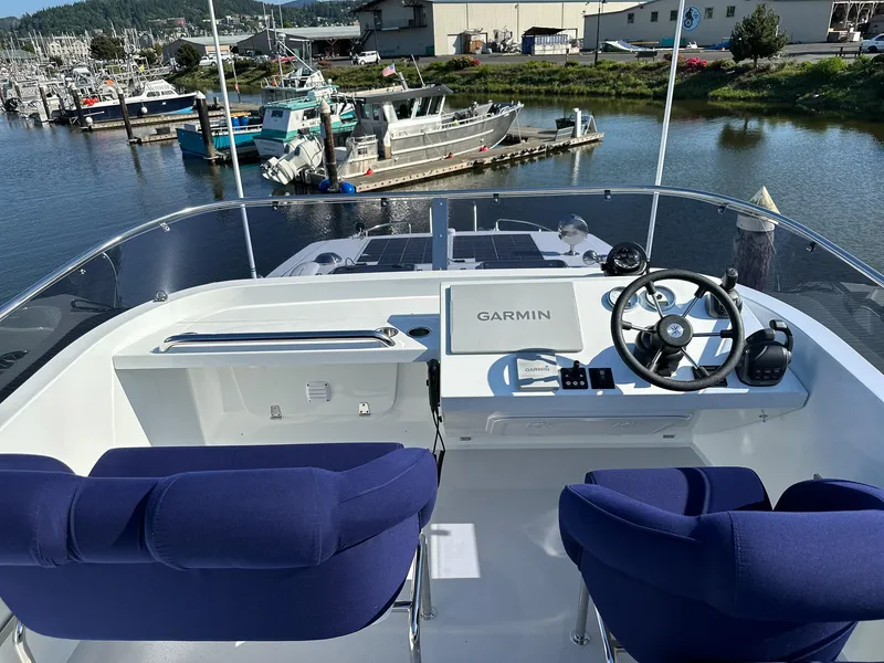 Slide: The Image of Flybridge of 2023 Targa 46 boat with Garmin navigation, overlooking marina. - 9