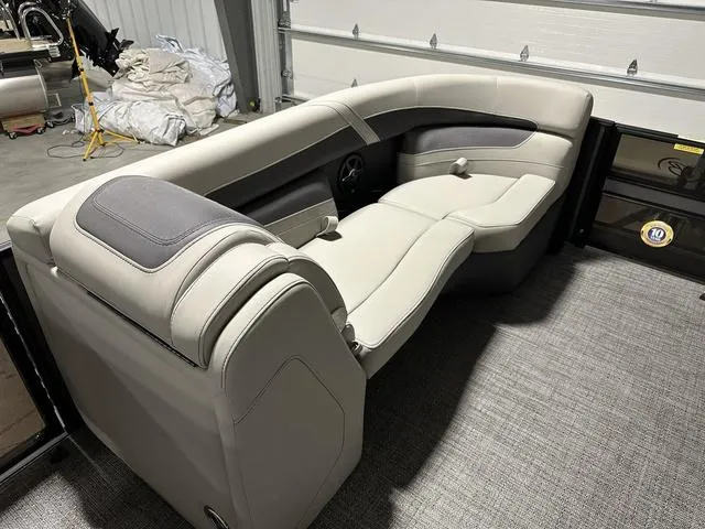 Slide: The Image of 2025 Barletta Cabrio C22UC boat interior with plush seating and modern dashboard. - 11
