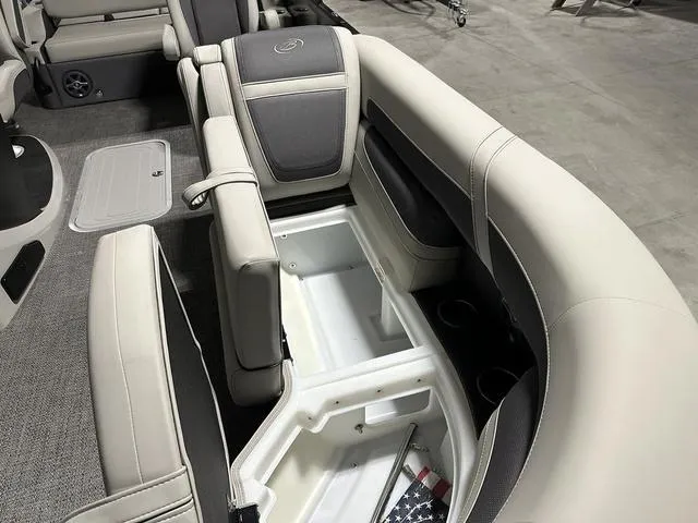 Slide: The Image of 2025 Barletta Cabrio C22UC boat interior with beige seating and cup holders. - 17