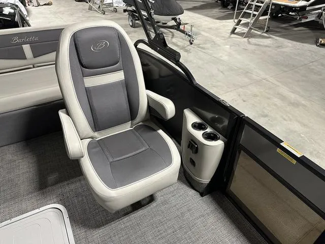 Slide: The Image of 2025 Barletta Cabrio C22UC boat interior with captain's chair and steering console. - 20