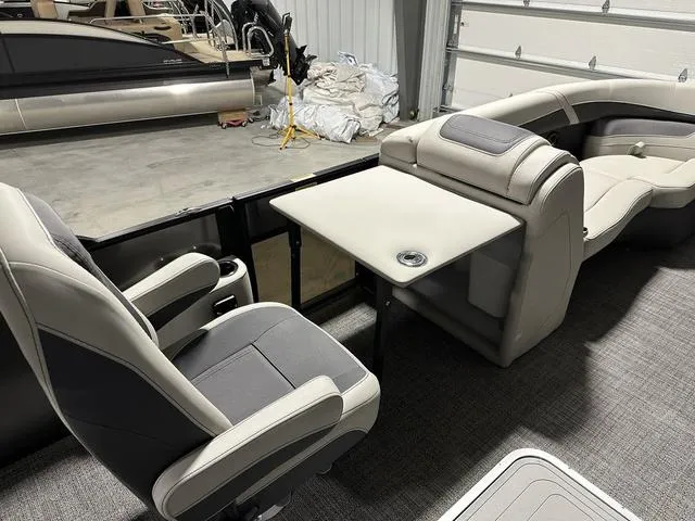 Slide: The Image of 2025 Barletta Cabrio C22UC boat interior with plush captain's chair and cup holders. - 21