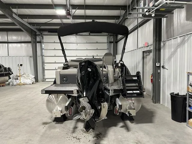 Slide: The Image of 2025 Barletta Boats Cabrio C22UC pontoon boat, rear view with motor and seating. - 3