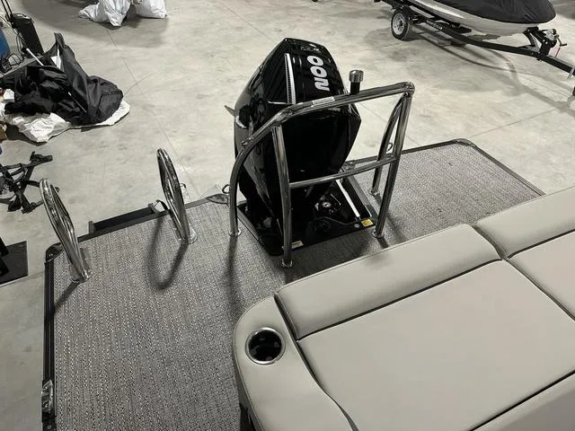 Slide: The Image of 2025 Barletta Cabrio C22UC boat interior with cushioned seating in a showroom. - 31