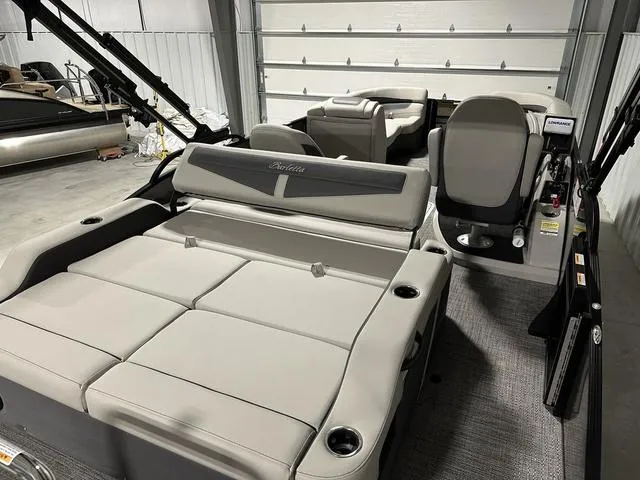 Slide: The Image of 2025 Barletta Boats Cabrio C22UC pontoon boat with modern seating and powerful outboard motor. - 4