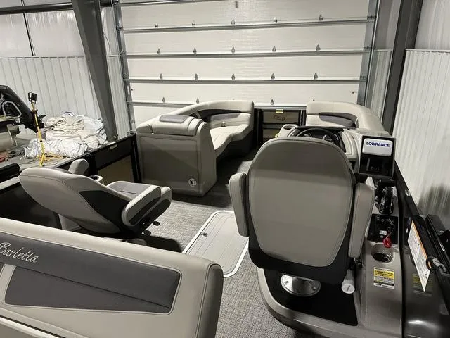 Slide: The Image of 2025 Barletta Boats Cabrio C22UC pontoon boat with luxurious seating and sleek design. - 5
