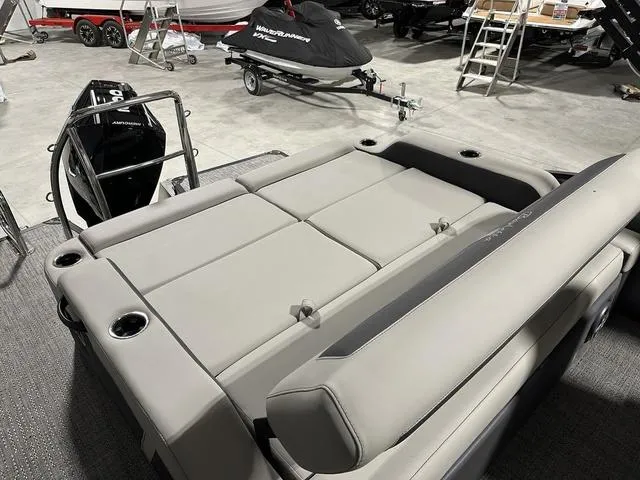 Slide: The Image of 2025 Barletta Boats Cabrio C22UC pontoon boat, front view, gray seating, black exterior. - 6