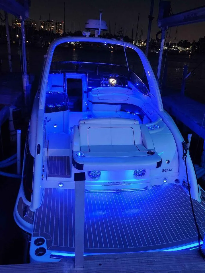 Slide: The Image of 2018 Formula 310 Sun Sport boat with blue LED lights at night. - 1