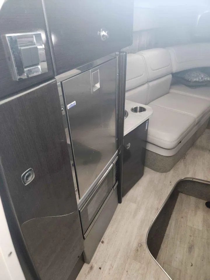 Slide: The Image of 2018 Formula 310 Sun Sport interior with modern kitchenette and seating area. - 12