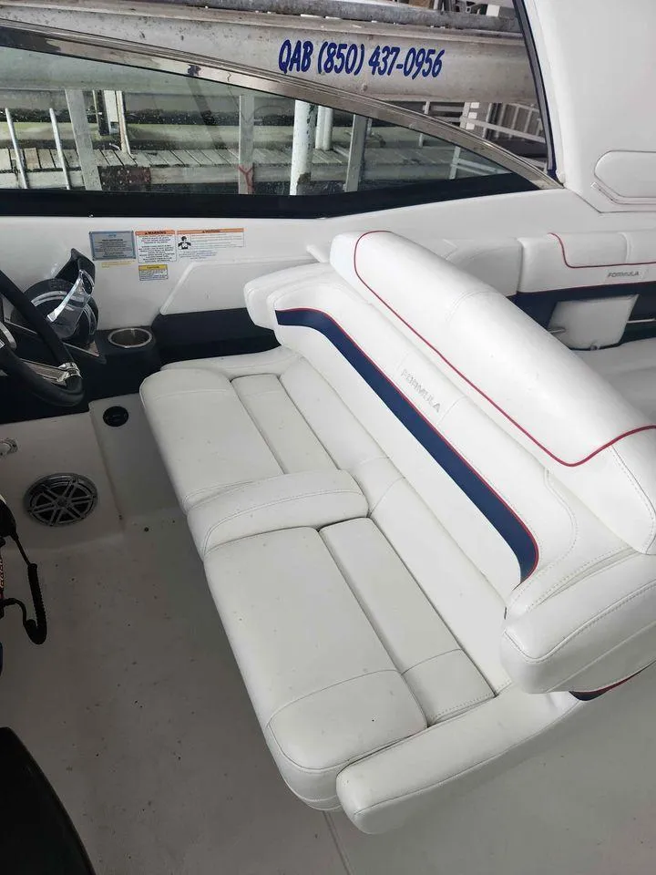 Slide: The Image of 2018 Formula 310 Sun Sport boat interior with white seating and blue accents. - 13