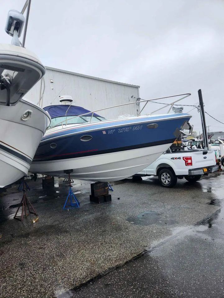 Slide: The Image of 2018 Formula 310 Sun Sport boat on a trailer in a marina. - 2