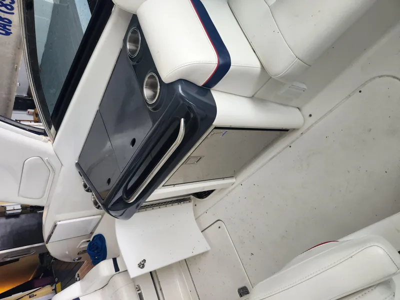 Slide: The Image of Interior of a 2018 Formula 310 Sun Sport boat with white seating and a compact kitchenette. - 24
