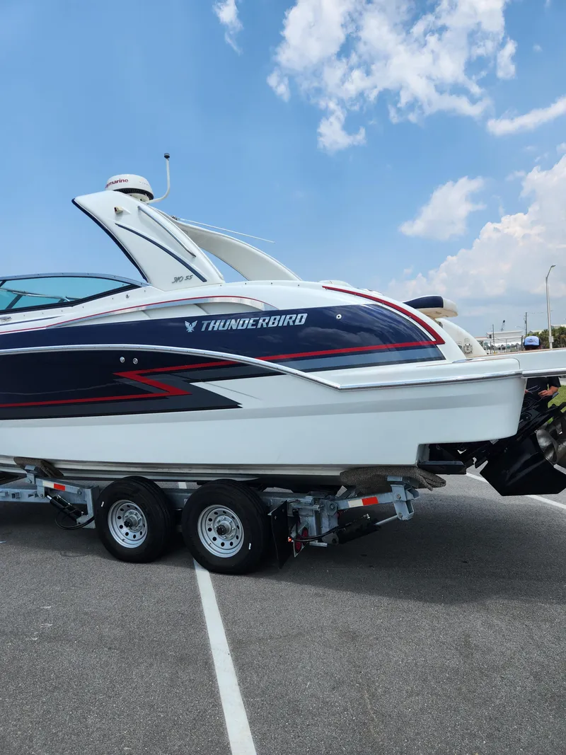 Slide: The Image of 2018 Formula 310 Sun Sport boat on a trailer under a blue sky. - 29