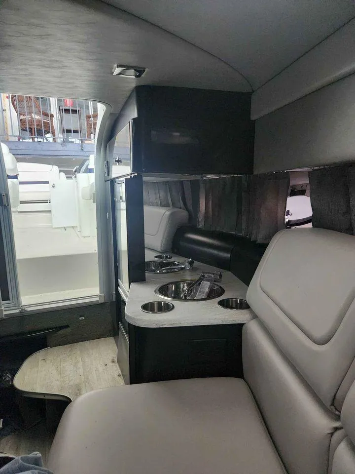 Slide: The Image of Interior of a 2018 Formula 310 Sun Sport boat with seating and kitchenette. - 30
