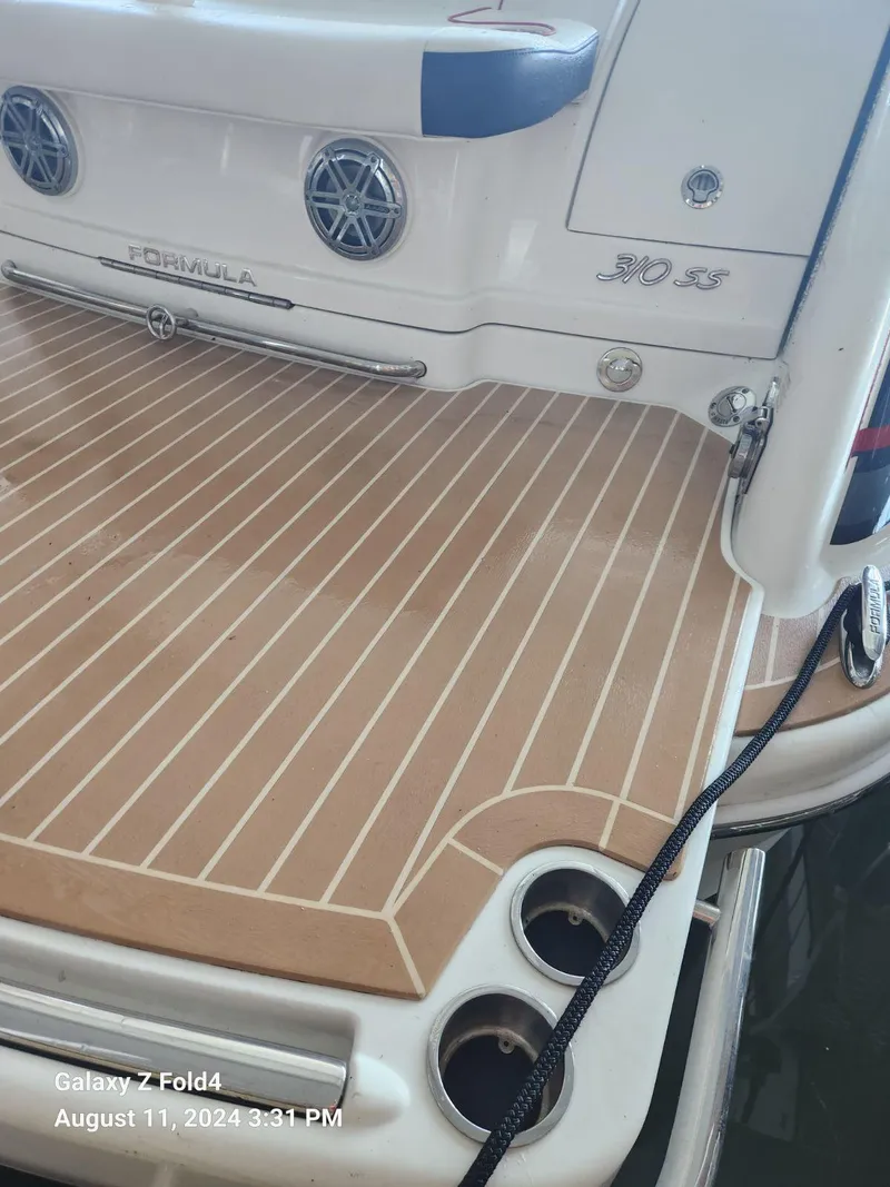 Slide: The Image of 2018 Formula 310 Sun Sport boat deck with speakers and cup holders. - 37