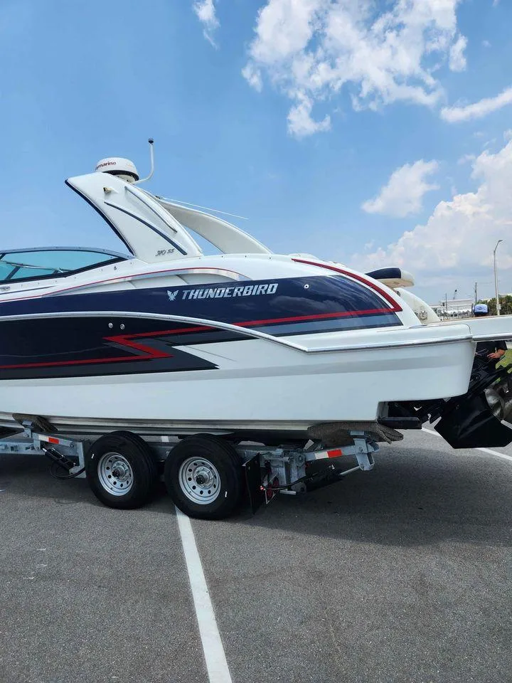 Slide: The Image of 2018 Formula 310 Sun Sport boat on a trailer under a blue sky. - 8