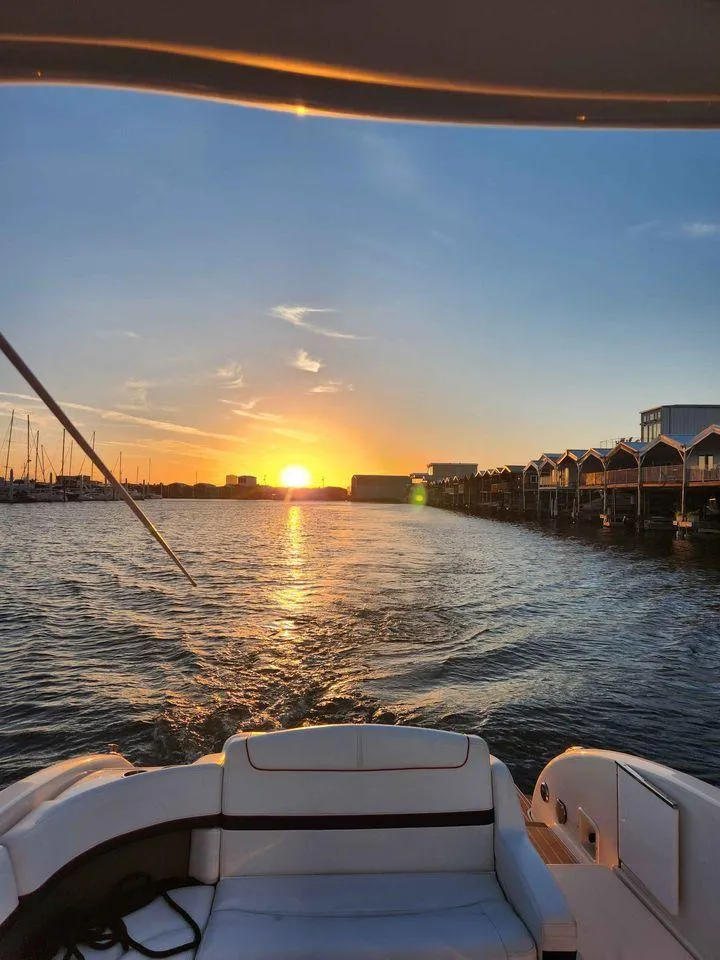 Slide: The Image of 2018 Formula 310 Sun Sport boat cruising at sunset on a serene waterway. - 9