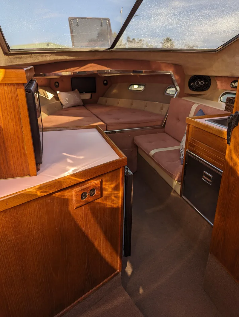 Slide: The Image of Interior of 1980 Tahiti Ocean Racer yacht with cozy seating and wooden cabinetry. - 3