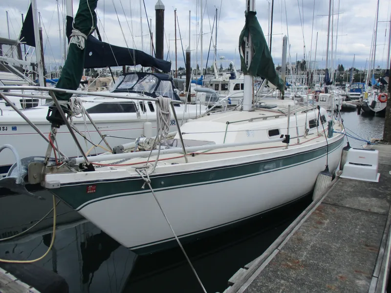 The Image of 1979 CAL 31 sailboat docked at marina, surrounded by other boats. - 0