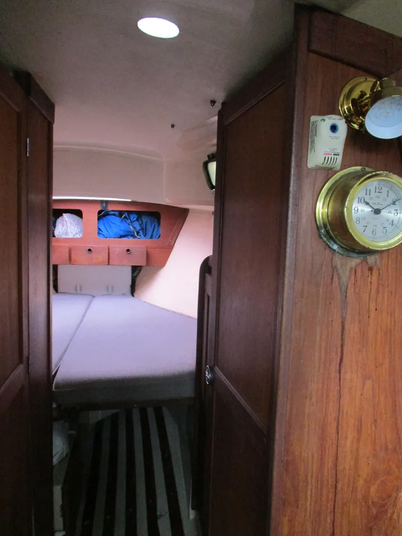 Slide: The Image of 1979 CAL 31 sailboat interior with wood paneling and cozy sleeping quarters. - 11