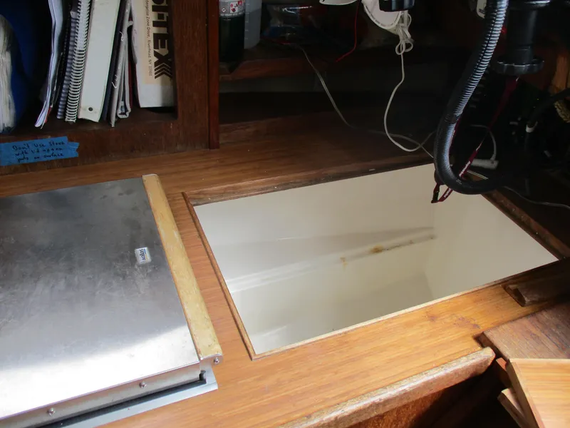 Slide: The Image of Interior of a 1979 CAL 31 sailboat with wooden desk and storage compartment. - 22