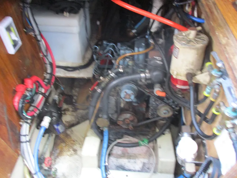 Slide: The Image of Engine compartment of a 1979 CAL 31 sailboat with visible wiring and components. - 25