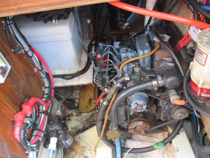 Slide: The Image of Engine compartment of a 1979 CAL 31 sailboat with visible wiring and components. - 28