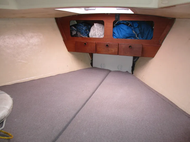 Slide: The Image of Interior cabin of a 1979 CAL 31 sailboat with storage and bedding. - 8