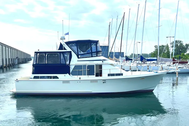 Slide: The Image of 1987 Tollycraft 44 Cockpit Motoryacht docked in a marina. - 0