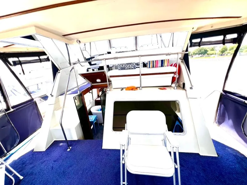Slide: The Image of 1987 Tollycraft 44 Cockpit Motoryacht interior with blue carpet and white seating. - 12