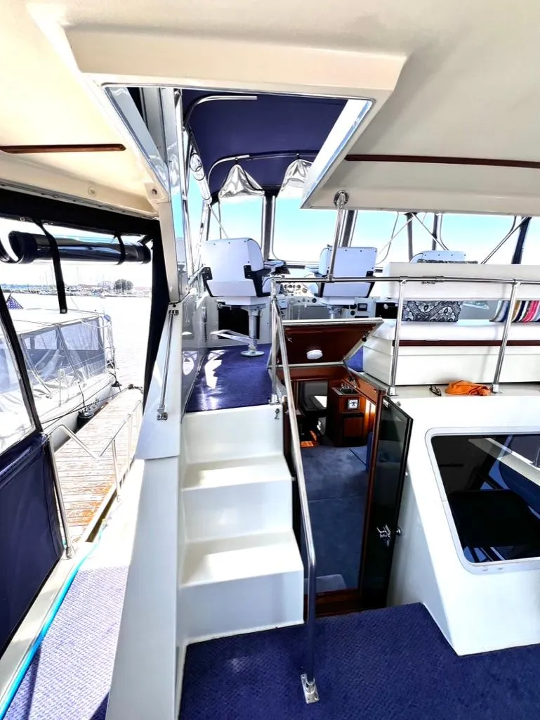 Slide: The Image of 1987 Tollycraft 44 Cockpit Motoryacht interior with stairs and seating area. - 14
