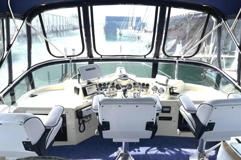 Slide: The Image of 1987 Tollycraft 44 Cockpit Motoryacht helm with navigation equipment and panoramic windows. - 15