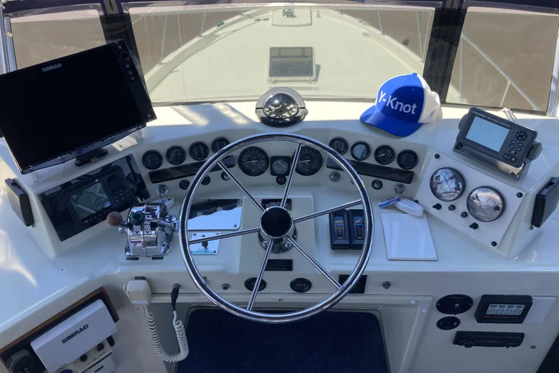Slide: The Image of Helm of 1987 Tollycraft 44 Cockpit Motor Yacht with steering wheel and navigation instruments. - 18
