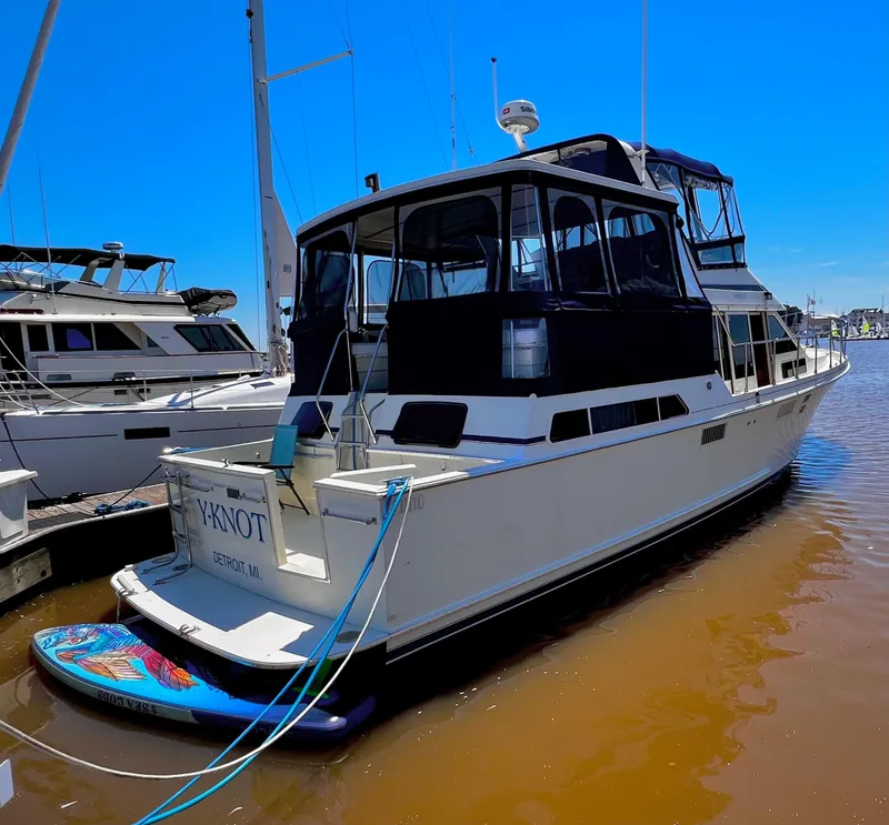 Slide: The Image of 1987 Tollycraft 44 Cockpit Motor Yacht docked in sunny marina. - 2