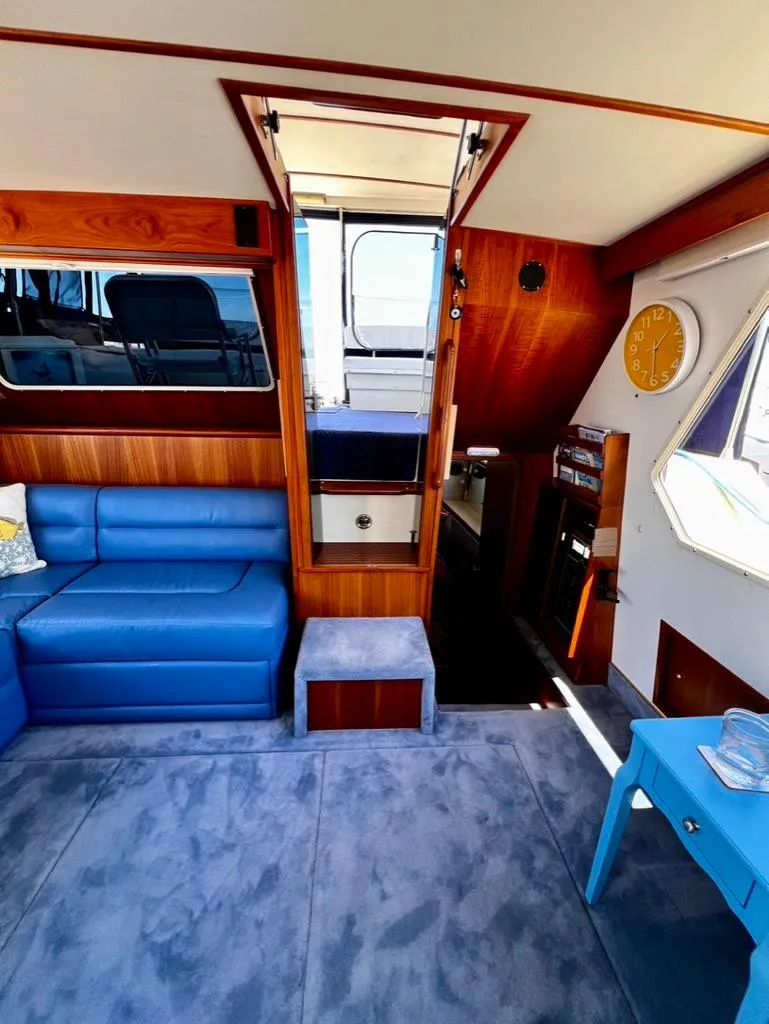 Slide: The Image of Interior of 1987 Tollycraft 44 Cockpit Motoryacht with blue seating and wooden accents. - 21