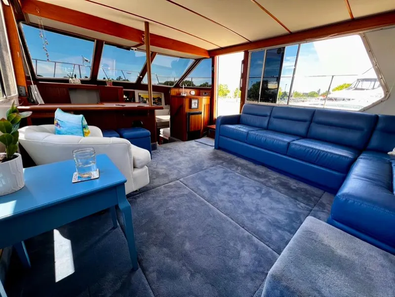 Slide: The Image of Interior of 1987 Tollycraft 44 Cockpit Motoryacht with blue seating and panoramic windows. - 25