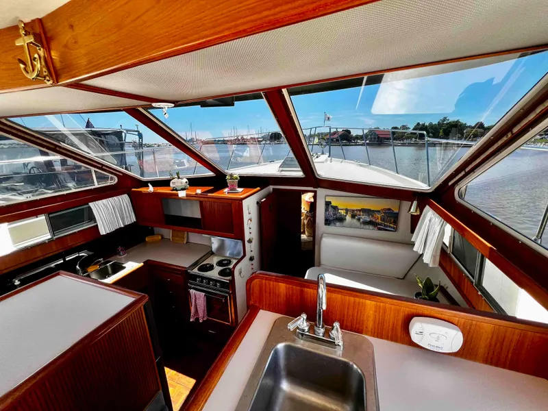 Slide: The Image of 1987 Tollycraft 44 Cockpit Motoryacht interior with kitchen and panoramic windows. - 27