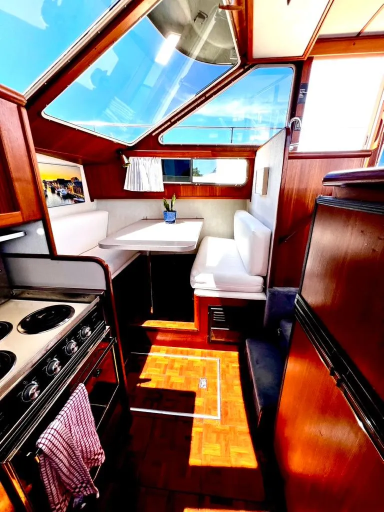Slide: The Image of Interior of 1987 Tollycraft 44 Cockpit Motoryacht with kitchen and dining area. - 28