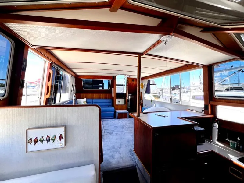 Slide: The Image of Interior of a 1987 Tollycraft 44 Cockpit Motoryacht with wood accents and marina view. - 30