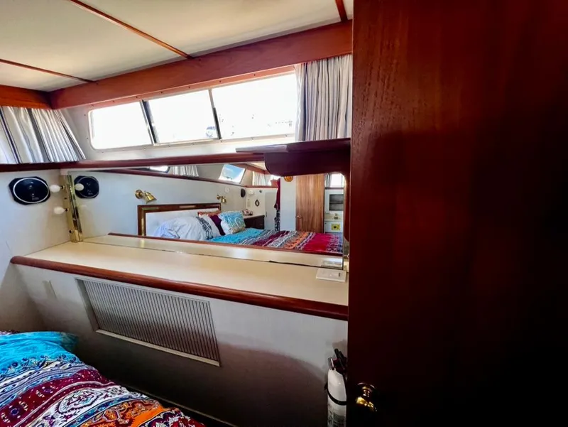 Slide: The Image of 1987 Tollycraft 44 Cockpit Motoryacht interior cabin with bed and window. - 39