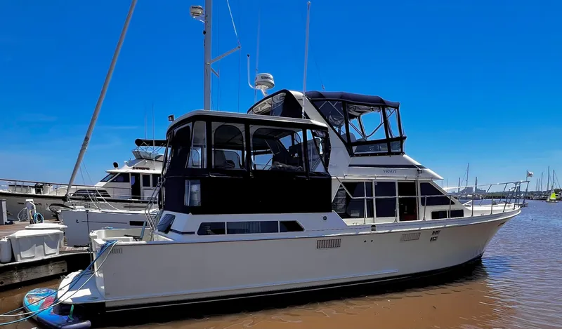 Slide: The Image of 1987 Tollycraft 44 Cockpit Motor Yacht docked at marina under clear blue sky. - 4