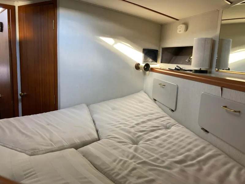 Slide: The Image of Cozy bedroom interior of 1987 Tollycraft 44 Cockpit Motor Yacht with white bedding. - 45