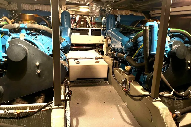 Slide: The Image of Engine room of a 1987 Tollycraft 44 Cockpit Motoryacht with twin blue engines. - 48