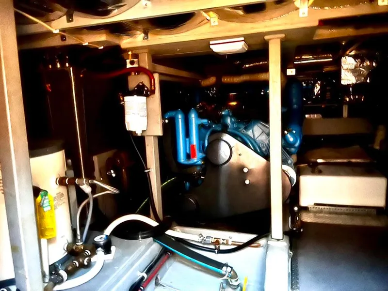 Slide: The Image of Engine room of a 1987 Tollycraft 44 Cockpit Motoryacht with visible machinery and components. - 49