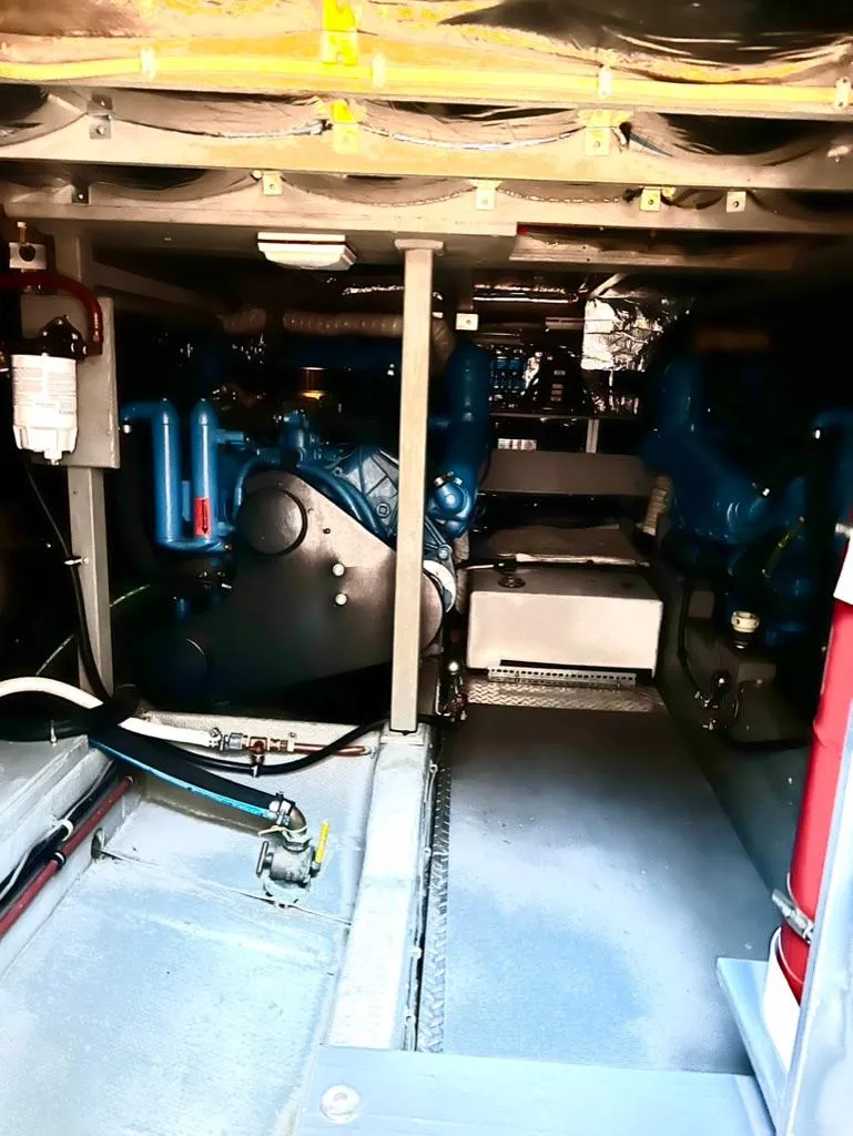 Slide: The Image of Engine room of a 1987 Tollycraft 44 Cockpit Motoryacht with visible machinery. - 50