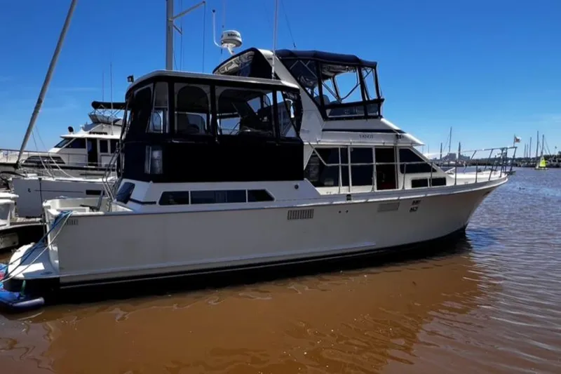 Slide: The Image of 1987 Tollycraft 44 Cockpit Motoryacht docked at marina on a sunny day. - 6