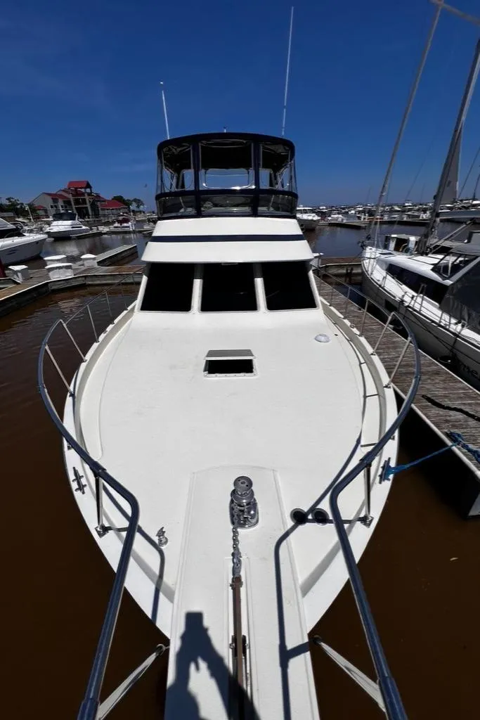 Slide: The Image of 1987 Tollycraft 44 Cockpit Motoryacht docked at marina. - 8