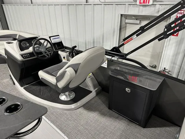 Slide: The Image of 2025 Barletta Boats Cabrio C24UE helm station with captain's chair and control panel. - 10