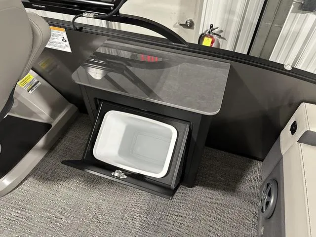 Slide: The Image of Barletta Boats Cabrio C24UE 2025 interior with built-in storage compartment. - 19