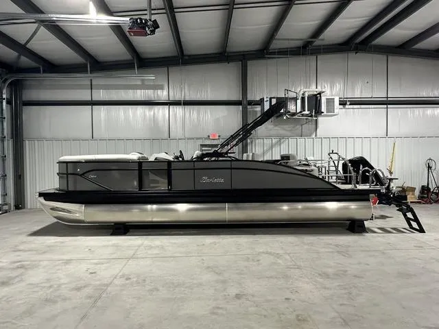 Slide: The Image of 2025 Barletta Boats Cabrio C24UE pontoon in a warehouse. - 2