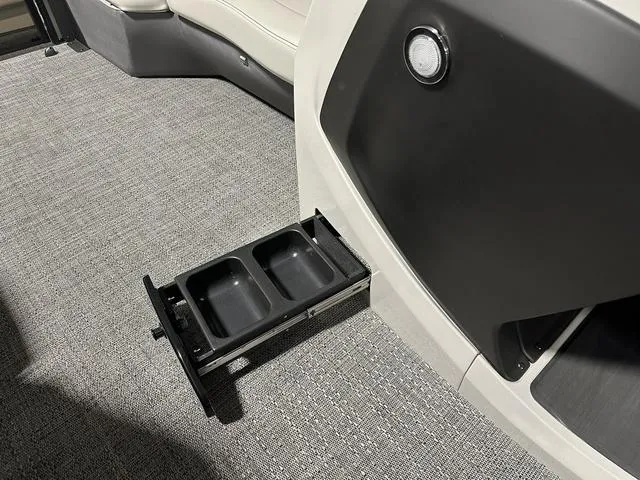 Slide: The Image of 2025 Barletta Boats Cabrio C24UE interior with retractable cup holders. - 21